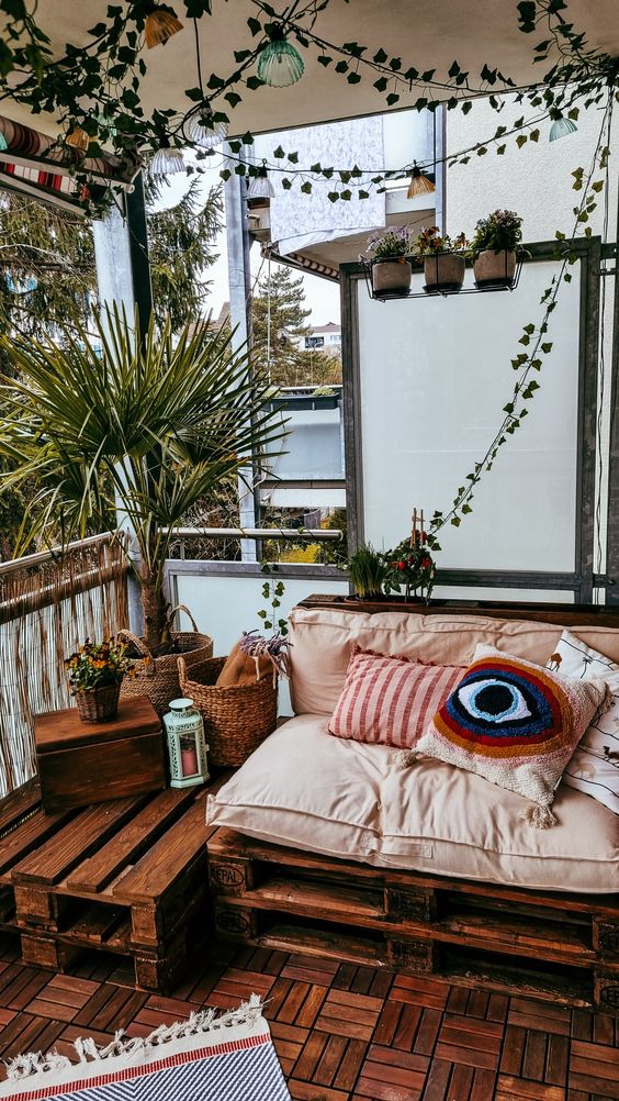 Woollen rugs and plants on a balcony for a warm and cosy winter vibe